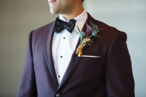 groom purple plum boutonniere