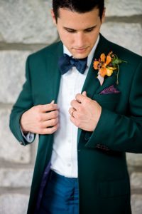 emerald tuxedo jacket orange boutonniere colorful groom fashion