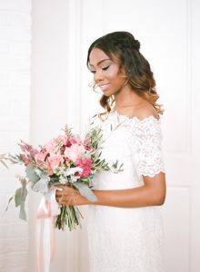 off the shoulder lace wedding dress pink peach magenta bridal bouquet half up half down bridal hair style