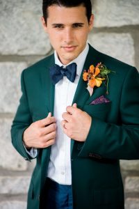 groom fashion emerald tuxedo jacket orange yellow purple boutonniere