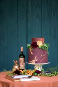wine cake table gold details maroon orange gold leaf wedding cake