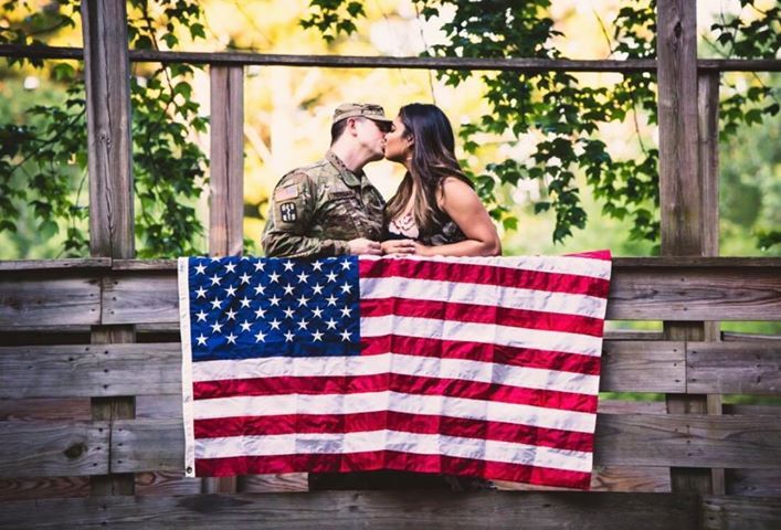 Couple kissing behind USA Flag