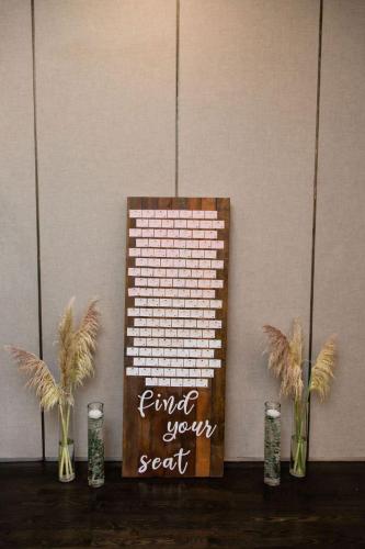 Rustic wooden seating chart at Tina & Josh's country club wedding.